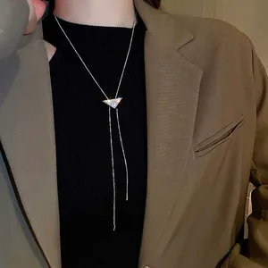 Silver Y-shaped long necklace with zircon triangle pendant and tassels on model