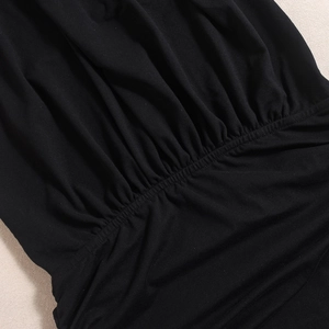 Detail of black elastic gathered waist fabric showing texture and ruching craftsmanship