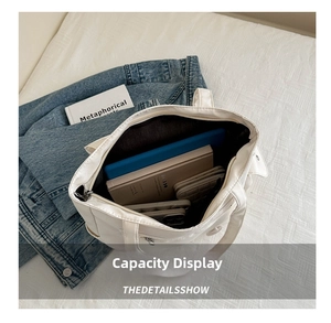 Large capacity interior of the white tote bag showing space for laptop and books
