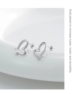 Detail of silver heart earrings showing the polished finish and durable gold plating