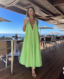 Detail of a vibrant lime green V-neck halter maxi dress perfect for summer beach vacations