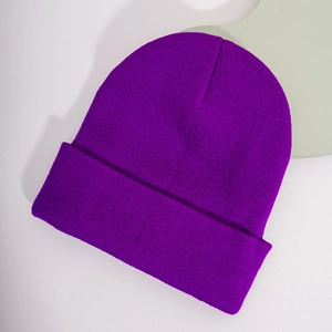 Detail of the fine ribbed knit texture and folded cuff on this purple beanie cap