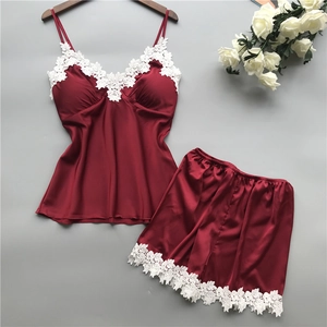 Detailed view of burgundy satin pajama set with intricate white floral lace trim details