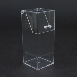 Macro shot of a clear acrylic lipstick storage box with lid on a black background