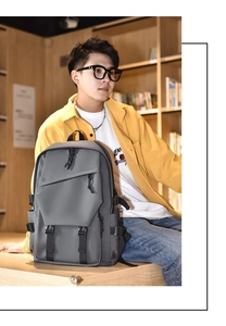 Macro shot of grey nylon backpack with multiple pockets and black buckles in library
