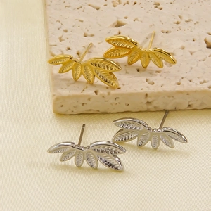 Minimalist 14K gold leaf stud earrings in gold and silver set on elegant display stone