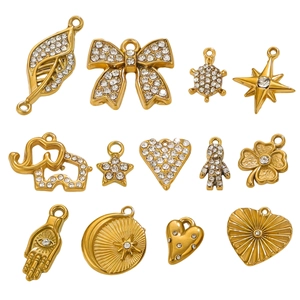 Detailed close-up of various gold stainless steel charms with crystals for DIY jewelry making