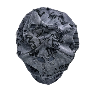 Detailed texture of grey knitted beanie with distressed holes and printed typography