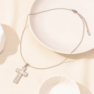 Macro shot of silver stainless steel cross pendant necklace with adjustable chain clasp