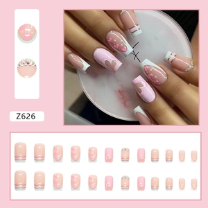 Light blue and pink square press-on nails with heart patterns, rhinestones and French tips