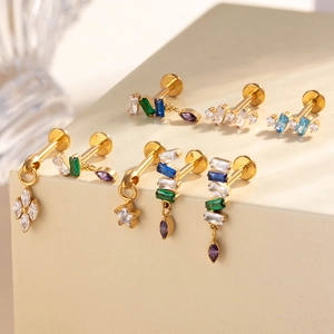 Titanium gold cartilage studs with crystal teardrop charms and geometric zircon inlays