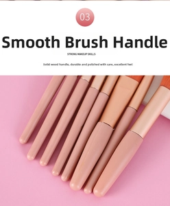 Detail of matte pink wooden handles and gold ferrules on professional makeup brushes