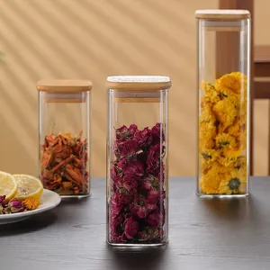 Three-piece square glass storage jar set with airtight wooden lids and dried flowers