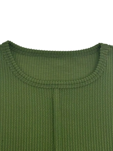 Close-up of green ribbed knit fabric neckline with detailed double-needle stitching