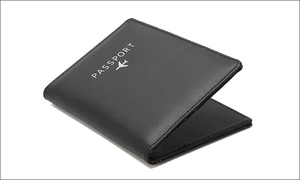 Detail view of black RFID passport holder with silver airplane icon and textured leather