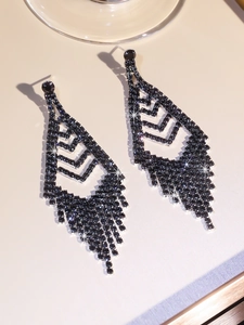 Macro shot of long black tassel earrings featuring hollow geometric design and rhinestones