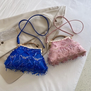 Detail of blue and pink evening bags with tassels, sequins and elegant metal handles