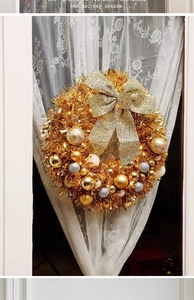 Detail of 45cm Christmas wreath with gold baubles, glitter bow and warm LED lighting