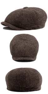 Detail view of brown herringbone newsboy cap fabric texture and eight-panel construction