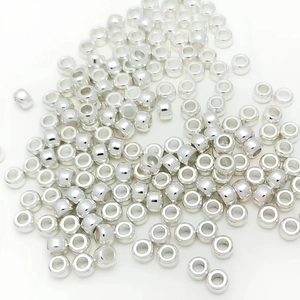 Macro detail of silver barrel spacer beads in polished metal for DIY jewelry making