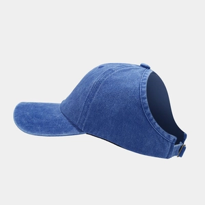 Detail of dark blue denim ponytail baseball cap with metal buckle and back opening