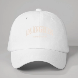 Close-up of Los Angeles vintage embroidery on a breathable white cotton baseball cap