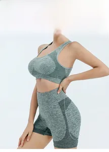 Detail of mesh paneling and light green marl texture on women's high-waist fitness shorts
