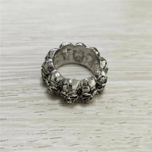 Detailed close-up of antique silver skull relief ring with punk gothic carved design
