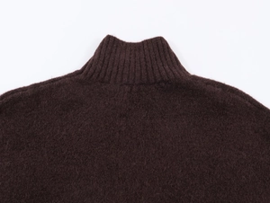 Detailed close-up of dark brown turtleneck knit sweater showing soft mohair wool texture