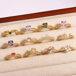 Detailed collection of gold rings with zircon and pearls in a velvet jewelry box