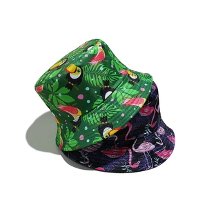 Detail of tropical print bucket hats featuring toucan and flamingo patterns on a white background