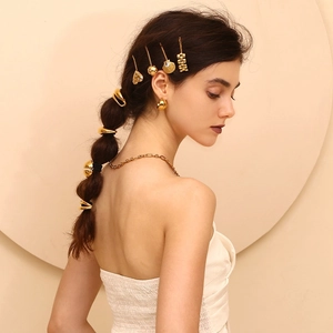 Detail of 18K gold plated stainless steel seashell hair clips worn on person