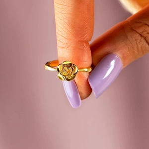 Elegant s925 silver rose flower ring in golden finish shown on finger with purple nails