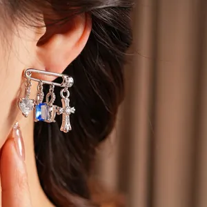 Silver pin earrings with heart cross charms and cubic zirconia for a punk luxury style