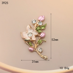 Macro detail of enamel flower brooch with pink buds, green leaves, and 31x52mm dimensions
