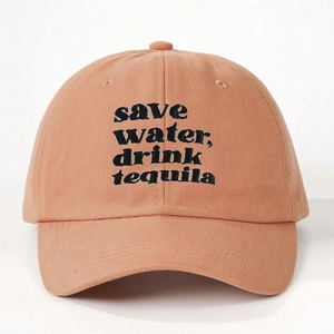 Detail of embroidered 'save water, drink tequila' slogan on pink cotton baseball cap