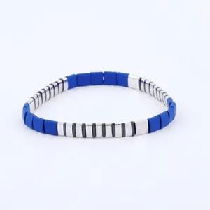 Detailed close-up of blue matte beads and silver metal beads on a stretchy bracelet