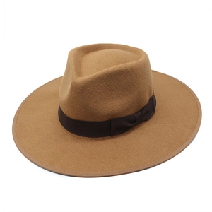 Classic camel wool fedora hat with dark brown silk ribbon and bow on white background