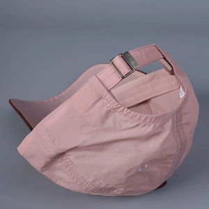 Detailed view of the adjustable metal buckle and neat stitching on a pink baseball cap