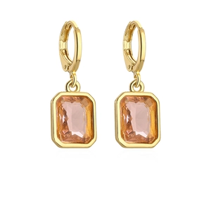 Close-up of gold-plated earrings featuring champagne rectangular faceted crystals