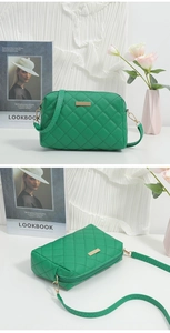 Detail of green quilted crossbody bag with rhombic stitching and gold metal plate