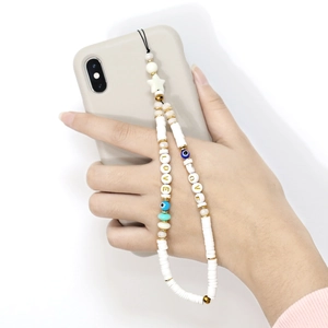 Bohemian beaded phone charm with LOVE letters, evil eye bead, and white clay discs