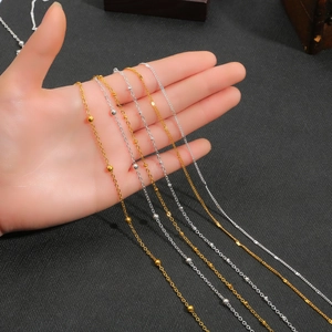 Close-up of DIY gold and silver iron bead chain necklaces for glasses and headphones