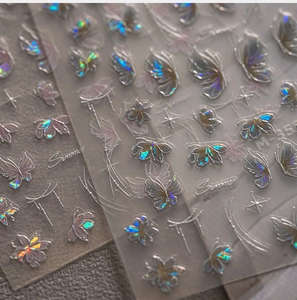 Macro shot of 3D embossed holographic butterfly nail stickers with laser floral patterns
