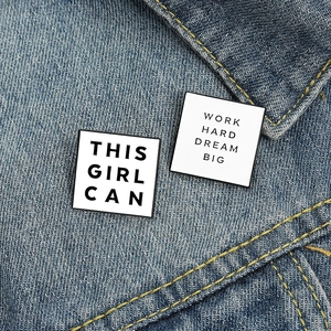 Enamel badges with 'This Girl Can' and 'Work Hard Dream Big' on blue denim jacket
