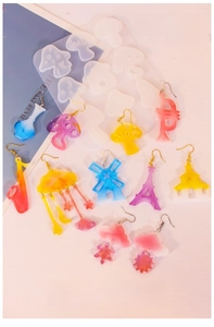 Macro view of silicone molds with finished resin charms in mushroom and cloud shapes
