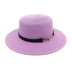 Detail of purple straw sun hat featuring black leather band and gold metal buckle