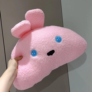 Detailed close-up of pink textured sherpa fabric on a cartoon animal plush pillow