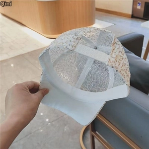 Detail of sequined baseball cap showing white breathable mesh back and adjustable buckle