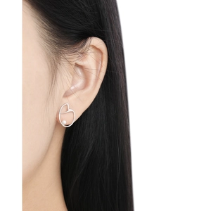 Minimalist S925 silver heart stud earrings with white pearl detail on female model